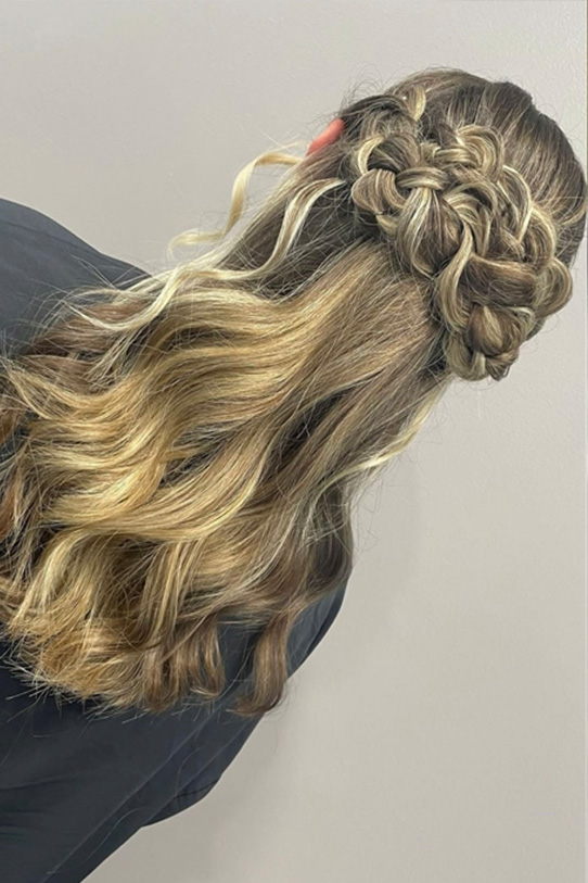 A client with intricate, bridal hair styling from behind